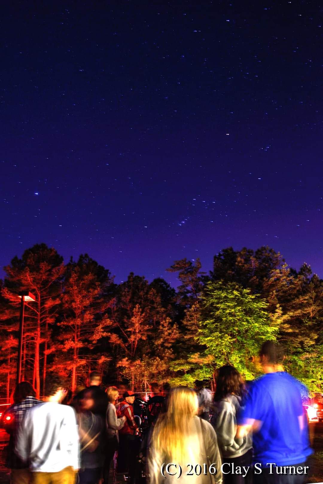Visitors under the night sky at HLCO public open house